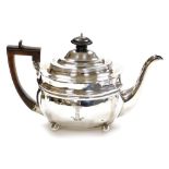 A George III silver teapot, with a reeded design body on bun feet, with an ebonised knop handle, mak