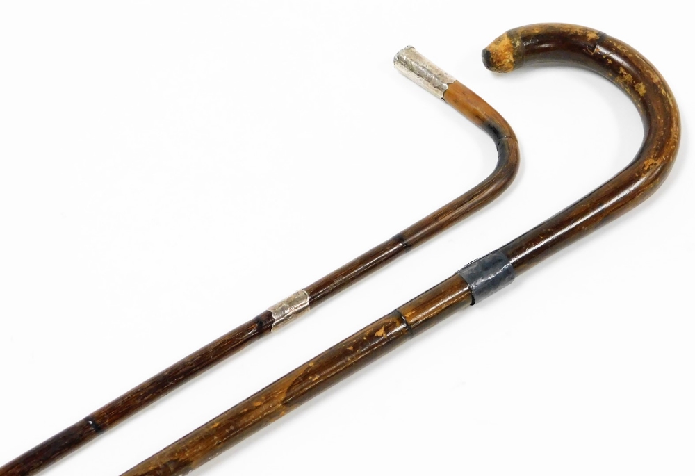 Two ebony and silver capped walking canes, one with silver collar, the other silver collar and termi