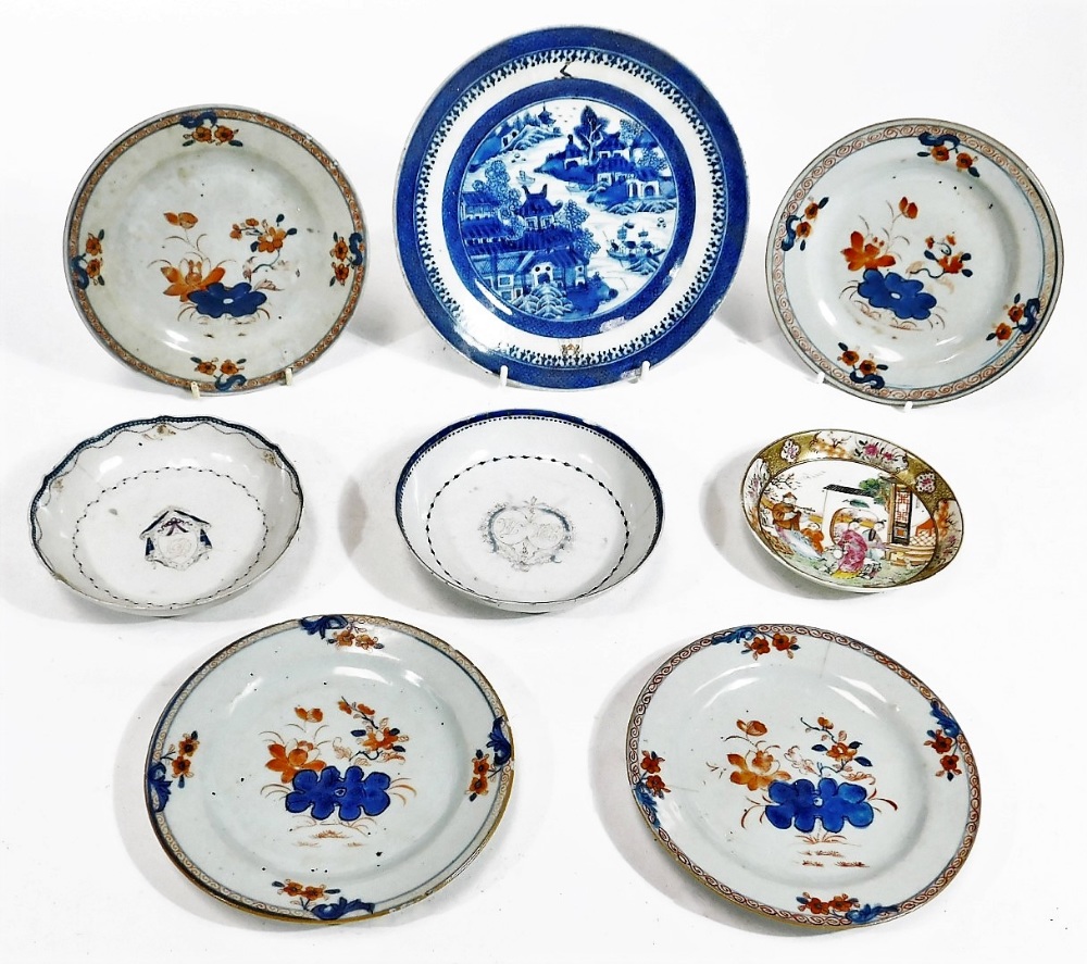 Two 18thC Chinese Export porcelain saucers, each centred with an armorial crest and initial, with an