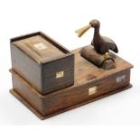 An early 20thC Japanese parquetry cigarette dispenser, with a bird picker, signed, 18cm wide.
