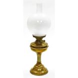 A brass oil lamp, with shade and reservoir on corinthian column, 50cm high.