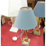 Three table lamps, to include a pair of brass Corinthian column table lamps and a marble effect tabl
