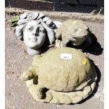 A group of garden ornaments, to include a toad, tortoise and Medusa head.