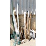 Various garden equipment, to include tools, snow shovel, bird feeders, sticks, a metal wall mounted
