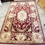 A wool cut rug, on a red and cream ground.