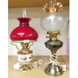 Two oil lamps converted to electricity, to include one hunting scene and red dome shade, the other w