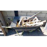 A metal wheelbarrow and contents, to include mainly tools, clips, shears, shovel, etc.