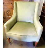 An Edwardian bedroom chair, upholstered in green Dralon, with walnut legs and castors, 81cm high, 60