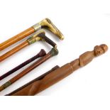 A collection of walking sticks and riding crops, to include an antler handle example, a riding