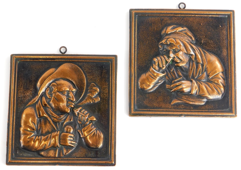 A pair of cast copper panels, each decorated with figures in Dutch style, 15cm x 14cm.