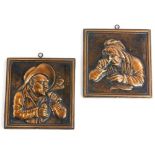 A pair of cast copper panels, each decorated with figures in Dutch style, 15cm x 14cm.