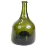 An 18thC green onion shaped green glass wine bottle, 21.5cm high. Reports are no longer given on