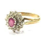 A 9ct gold ruby and diamond cluster ring, set with oval cut ruby in claw setting, surrounded by tiny