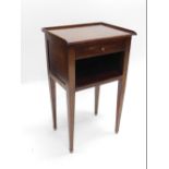 A mahogany bedside table, with a raised gallery, single drawer above a recess, on square tapering