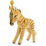 A vintage Steiff Zebra, with original paper label and pin or button to ear, 17cm long.