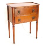 A French fruitwood bedside table, with a raised gallery, above two drawers, each with lion mask