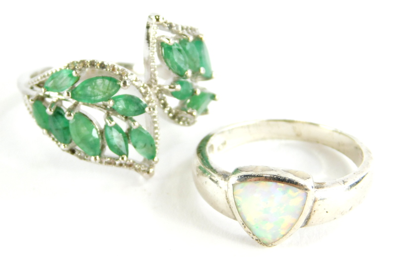 Two silver dress rings, to include one set with opal, the other two fern design set with green