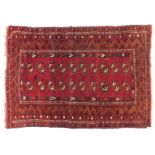 A Turkoman type rug, with a design of two rows of medallions, on a red ground, 95cm x 133cm.