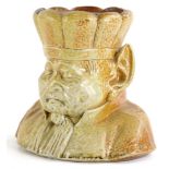 A Victorian stoneware tobacco jar, modelled in the form of a goblin type figure, wearing a hat or