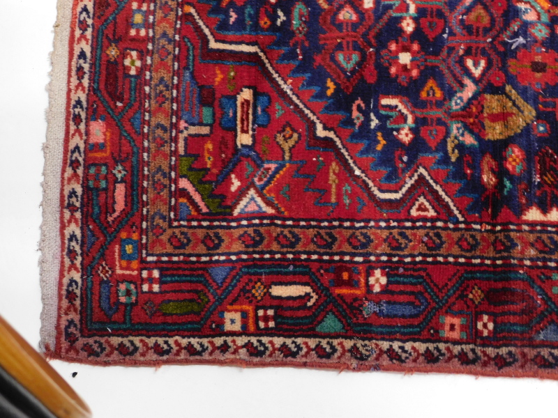 A Persian rug, with a central medallion, surrounded by geometric motifs on a blue ground, 245cm x - Image 2 of 3