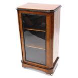 A narrow Victorian walnut and ebonised display cabinet, the top with canted corners, above a