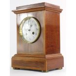An Edwardian mahogany boxwood strung and chequer banded mantel clock, with white enamel dial, on bun
