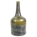 An 18thC green glass wine bottle, 23cm high. Reports are no longer given on antique bottles.