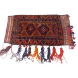A Persian saddle bag, with a navy and red pole medallion, on an orange ground, 56cm x 110cm.