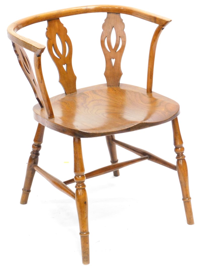 A mid 20thC ash and elm captains type chair, with a pierced splat, turned legs and H stretcher.