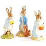 Three Beswick Beatrix Potter figures, Peter Rabbit with daffodil, Mrs Rabbit cooking and Peter