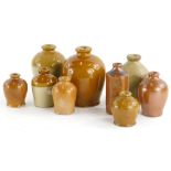 A collection of small stoneware bottles, various sizes, possibly relating to medicine, some stamped,