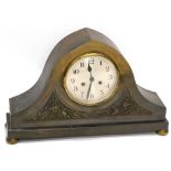 An unusual early 20thC patinated brass mantel clock, of arched form with two panels, each