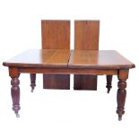 An oak extending dining table, the rectangular top with canted corners, two loose leaves, 73cm high,