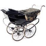 A coach built Silver Cross baby pram, in black and white livery, 140cm long.