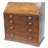 A George III mahogany bureau, the fall enclosing a fitted interior above four graduated drawers,