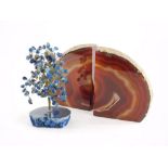 A pair of polished onyx bookends, 15cm high, and a lapis model of a tree and stand.