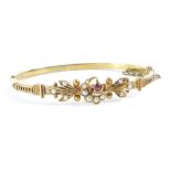 A Victorian/Edwardian hinged bangle, with crescent moon and star decoration, set with ruby and