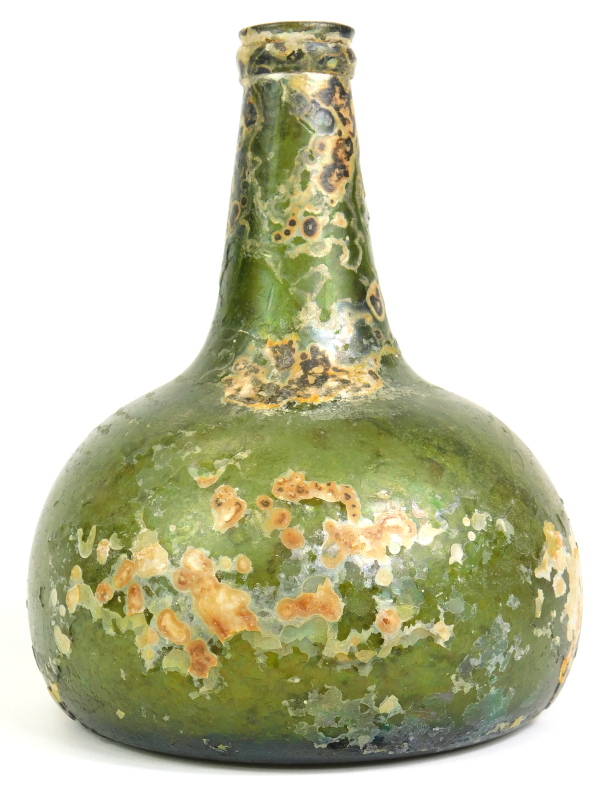 An 18thC green glass onion shaped wine bottle, signs of excavation, 19cm high. Reports are no longer