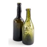 Two 19thC green glass wine bottles, 24cm and 22cm high.