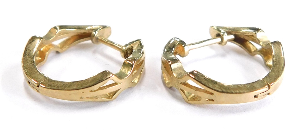 A pair of 9ct gold hoop earrings, each of hinged design with pierced decoration, the ring hoop 2cm