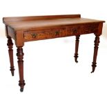 A Victorian pitch pine side or writing table, with a raised back above two frieze drawers, each with
