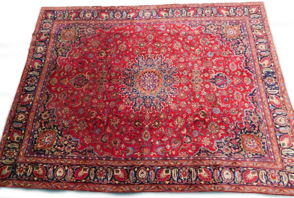 A large Persian Meshed type carpet, with a central medallion, surrounded by an elaborate design to