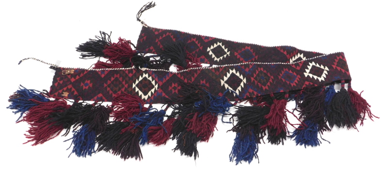 A Persian Kilim tent hanging or harness, with a geometric design and tassels, 220cm x 15cm.