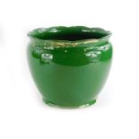 A green glazed pottery jardiniere, picked out in gilt, (AF), 29cm diameter.