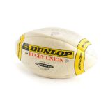 A Dunlop Promotional Rugby Union ball, bearing various signatures of the New Zealand Rugby team.