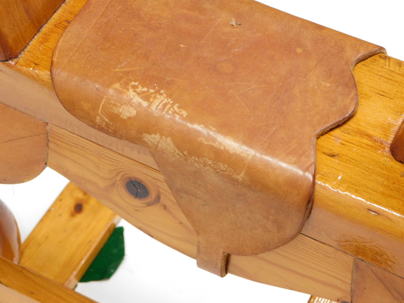 A carved pine child's rocking horse, with leather saddle and ebonised metal mounts, on a trestle - Image 2 of 2