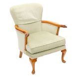 A mahogany armchair, upholstered in green fabric, the shaped arms carved with eagles heads, on