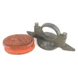 A Robey of Lincoln clamp for working water level, and an oval cast iron weight, painted red. (2)