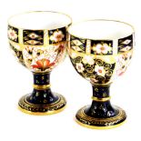 A pair of Royal Crown Derby porcelain goblets, each decorated with the Imari pattern, printed