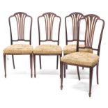 A set of four early 20thC mahogany dining chairs, in Hepplewhite style, each with a pierced and